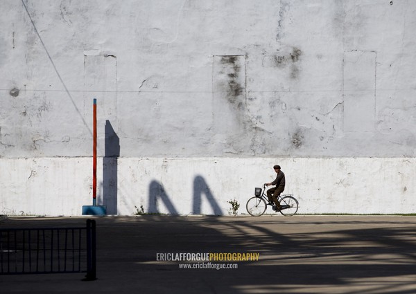 North Korean man riding a bicycle in Hungnam nitrogen fertilizer plant, South Hamgyong Province, Hamhung, North Korea