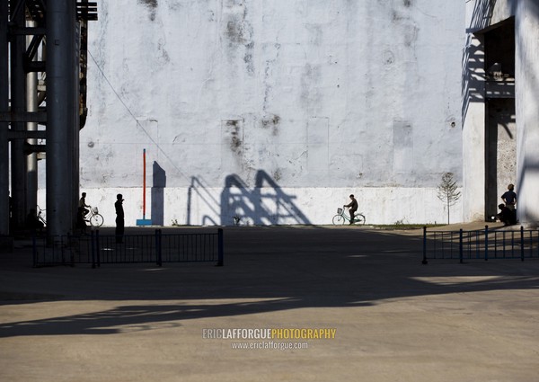 North Korean man riding a bicycle in Hungnam nitrogen fertilizer plant, South Hamgyong Province, Hamhung, North Korea