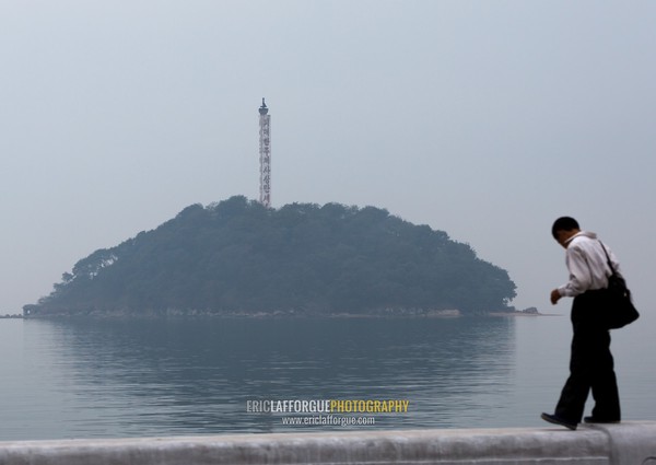 North Korean man in front of a small island, South Hamgyong Province, Hamhung, North Korea