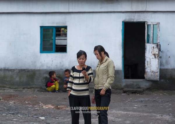 North Korean women with a mobile phone in the countryside, Pyongan Province, Pyongyang, North Korea