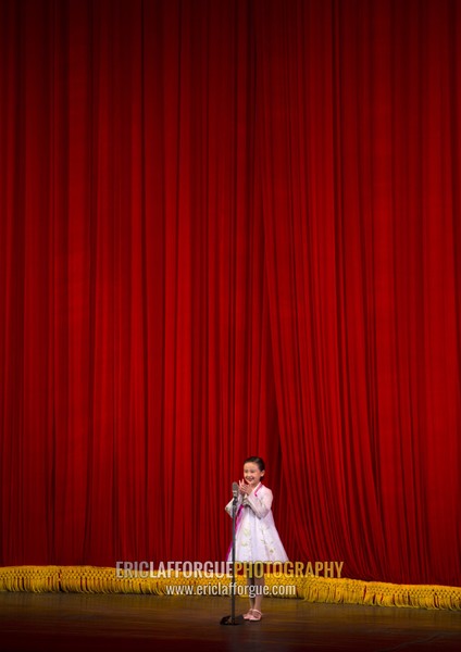 Young artist singing on stage in Mangyongdae children's palace, Pyongan Province, Pyongyang, North Korea