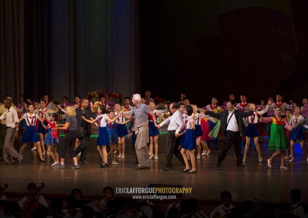 Young North Korean artists dancing with tourists at the end of their show in Mangyongdae children's palace, Pyongan Province, Pyongyang, North Korea