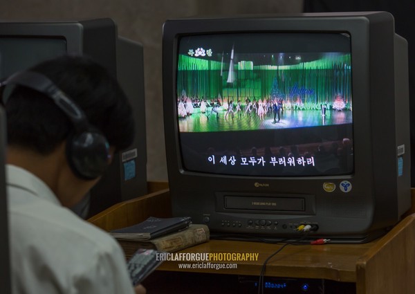 North Korean man watching a video tape in the multimedia room of the Grand people's study house, Pyongan Province, Pyongyang, North Korea