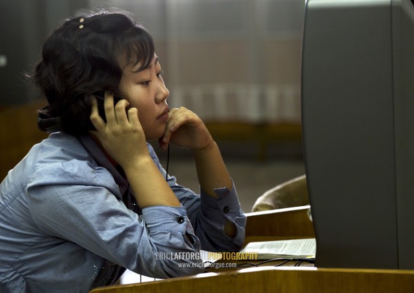 North Korean woman watching a dvd at the Grand people's study house, Pyongan Province, Pyongyang, North Korea