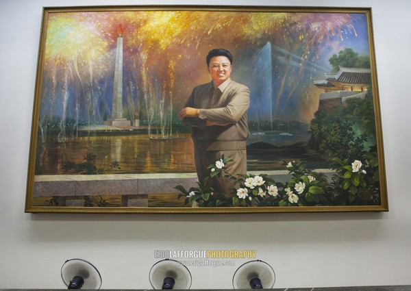 Fans cooling a Kim Jong il portrait in front of the Juche tower at the Grand people's study house, Pyongan Province, Pyongyang, North Korea