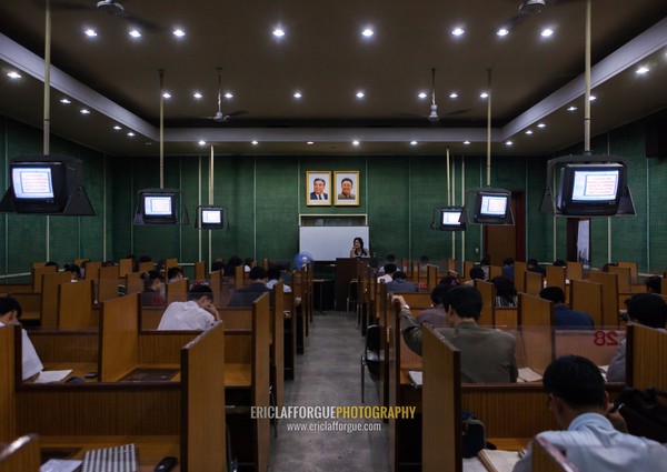 North Korean students during an english classroom in the Grand people's study house under the official portraits of the Dear Leaders, Pyongan Province, Pyongyang, North Korea