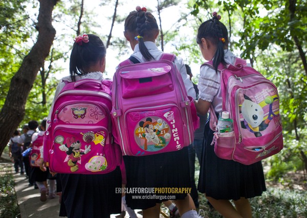 North Korean girls with Mickey bags on their backs going to school, Pyongan Province, Pyongyang, North Korea