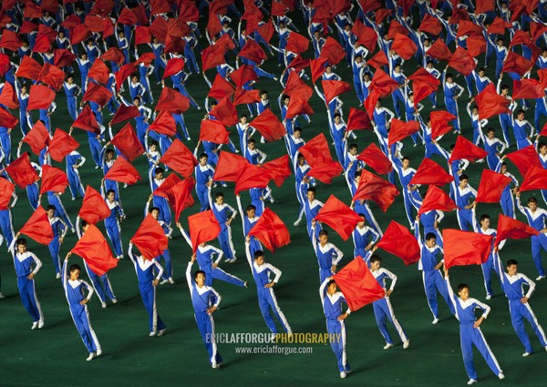 North Korean gymnasts with red flags during the Arirang mass games in may day stadium, Pyongan Province, Pyongyang, North Korea