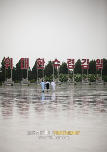 North Korean women under the rain in Kumsusan memorial palace, Pyongan Province, Pyongyang, North Korea