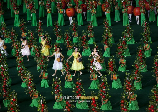 North Korean women dancing between apples during the Arirang mass games in may day stadium, Pyongan Province, Pyongyang, North Korea