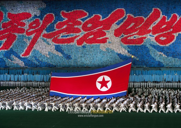 North Korean taekwondo team in front of a giant flag during the Arirang mass games in may day stadium, Pyongan Province, Pyongyang, North Korea