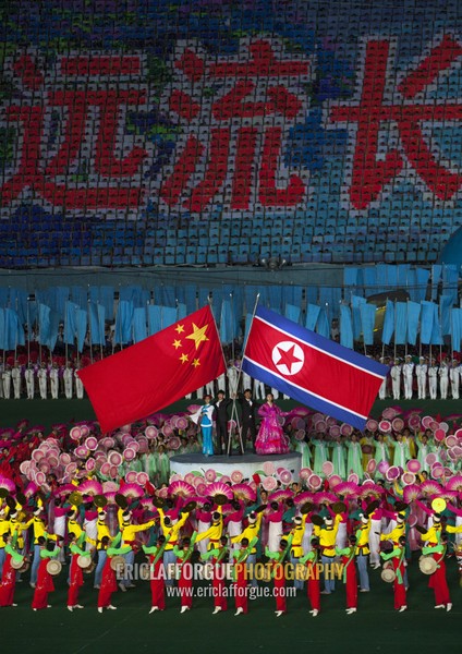 North Korean and chinese flags during the Arirang mass games in may day stadium, Pyongan Province, Pyongyang, North Korea